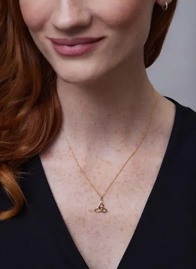 Close up shot of red haired model wearing 14ct Gold Trinity Knot Pendant